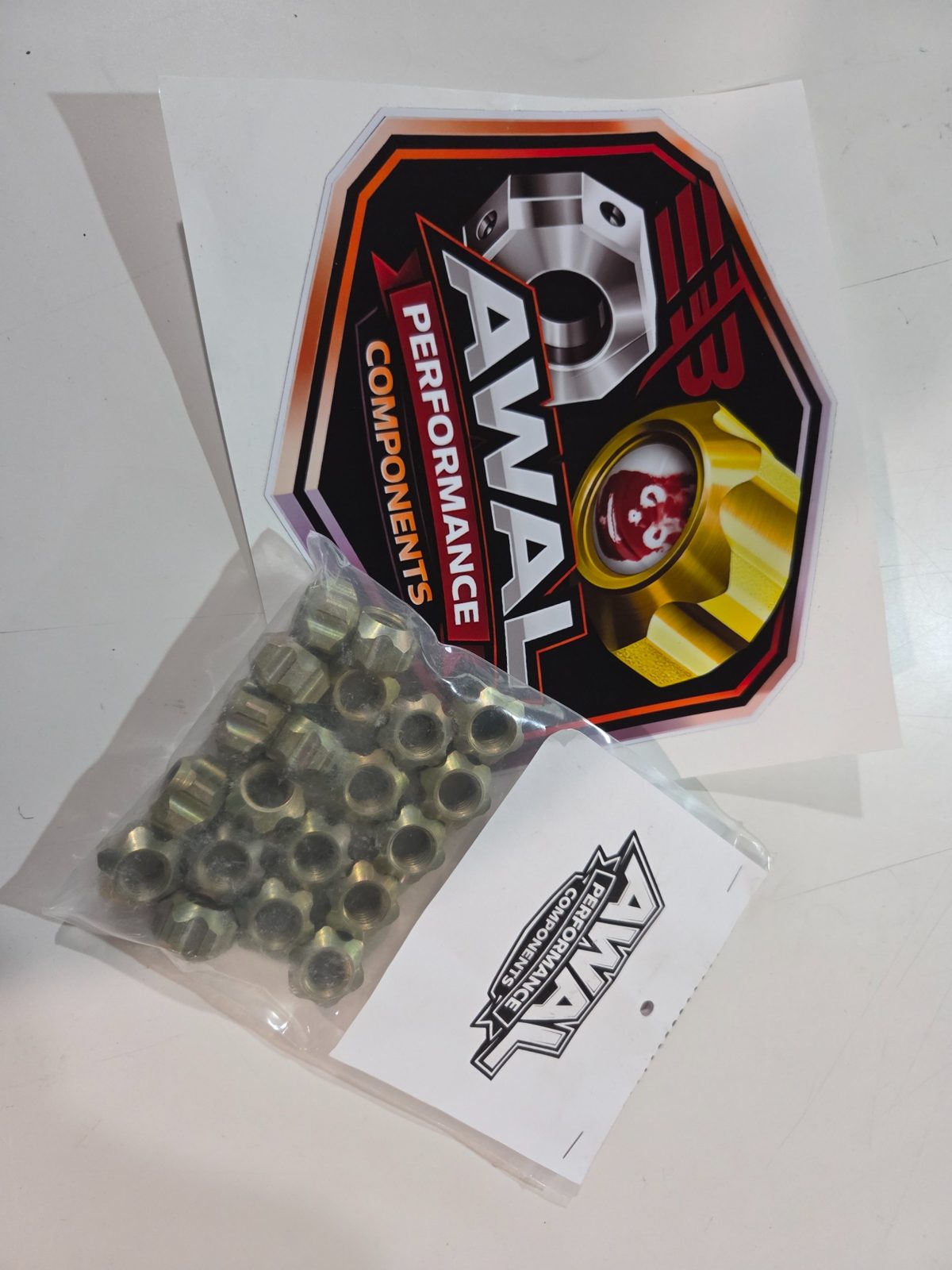 Bagged AWAL racing lug nuts with AWAL Performance Components decals