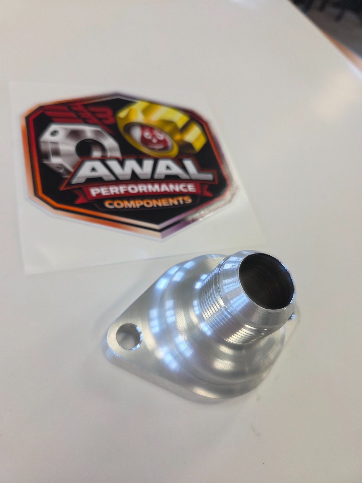 Machined aluminum AWAL adapter fitting on a light background